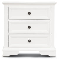 A white three-drawer nightstand with black round knobs, shown against a plain white background.