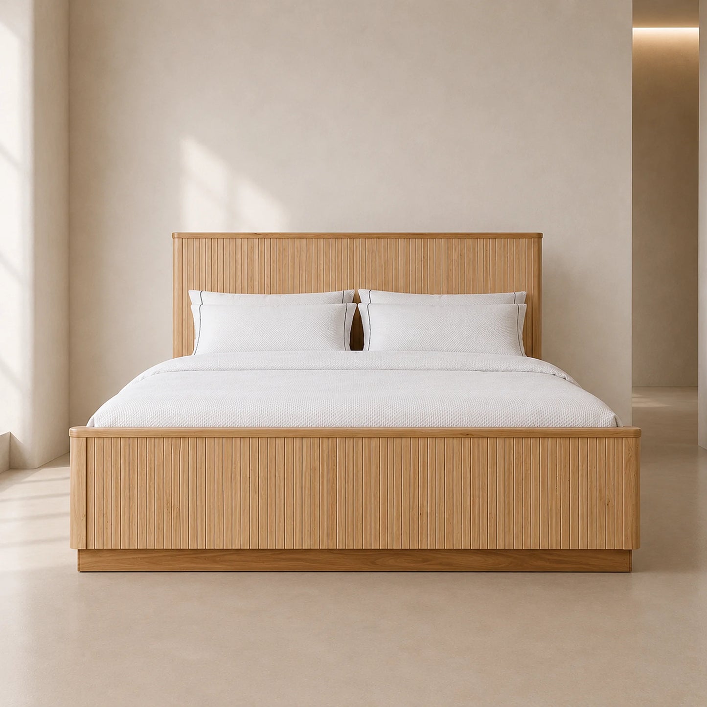 A modern platform bed with a light natural wood slatted headboard and footboard, dressed in white bedding and pillows, set against a minimalist beige wall and floor.