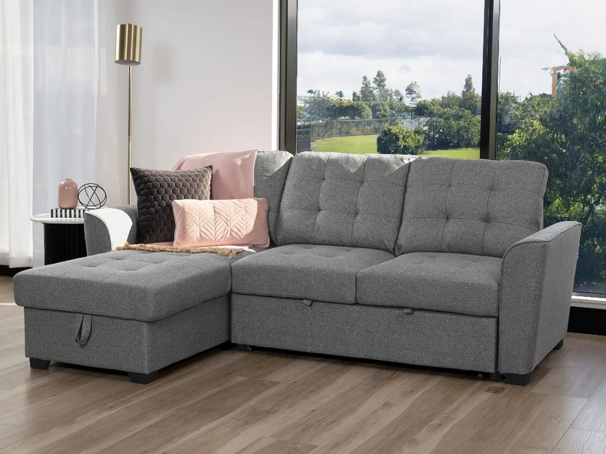 Aurore 2 seater sofa bed with grey upholstery, button-tufted cushions and storage chaise shown on the left side of the image
