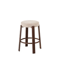 A single bar stool with a round upholstered seat in a light beige fabric and four dark brown wooden legs, shown against a plain white background.
