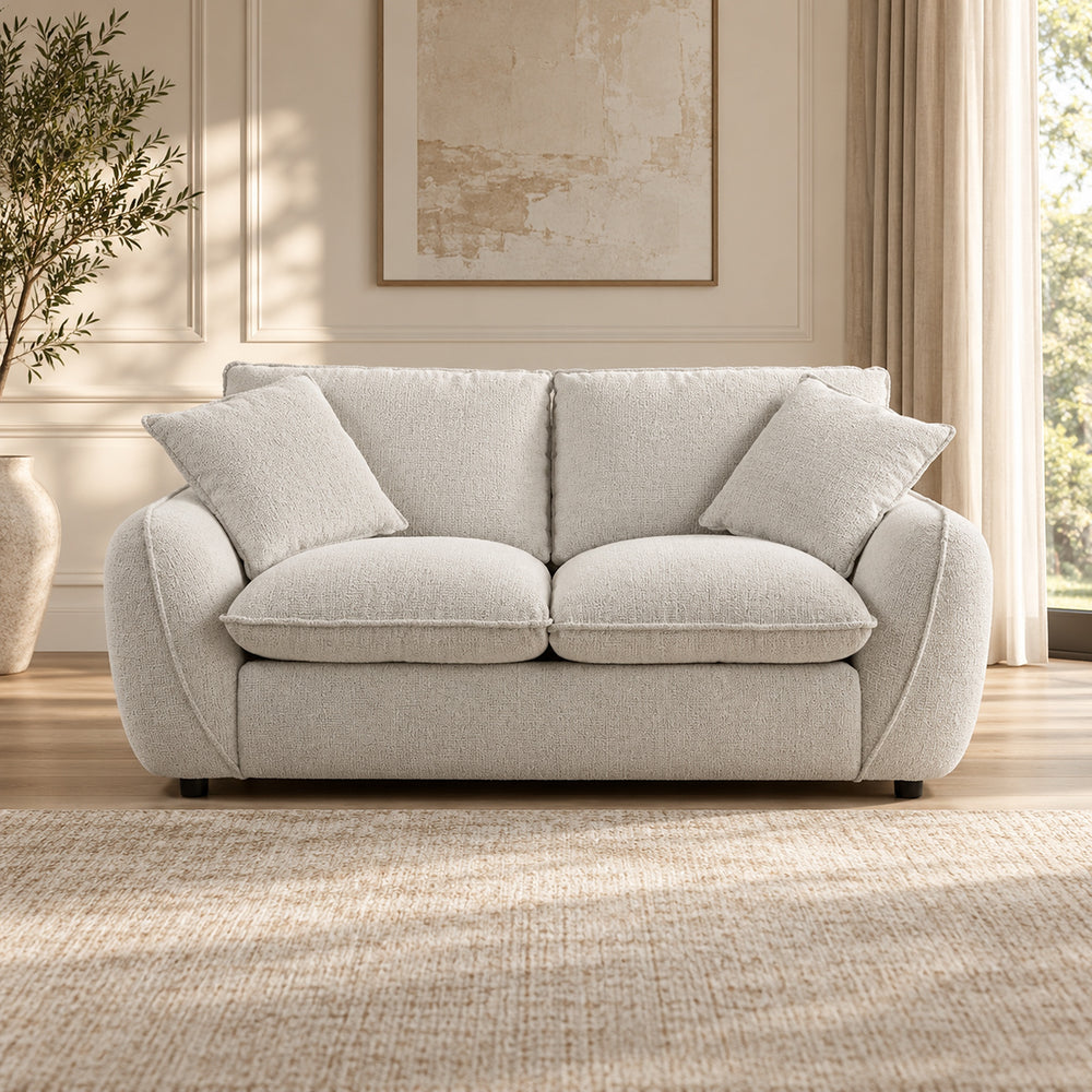 Bradman Snow 2 seater duck feather sofa with curved arms, plush cushions and textured Shay fabric upholstery, front view