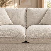 Bradman Snow 2 seater duck feather sofa with curved arms, plush cushions and textured Shay fabric upholstery, close up view