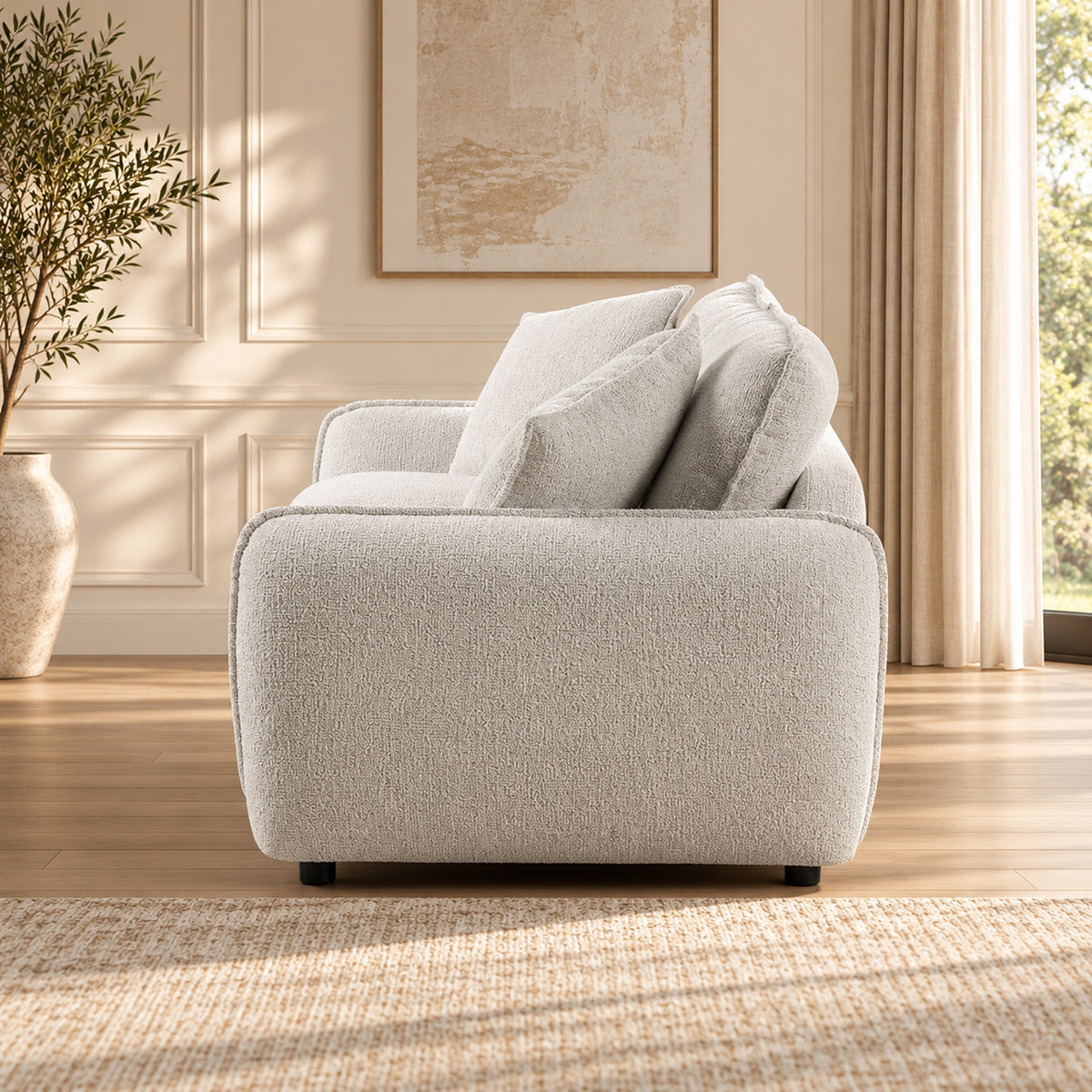 Bradman Snow 2 seater duck feather sofa with curved arms, plush cushions and textured Shay fabric upholstery, side view