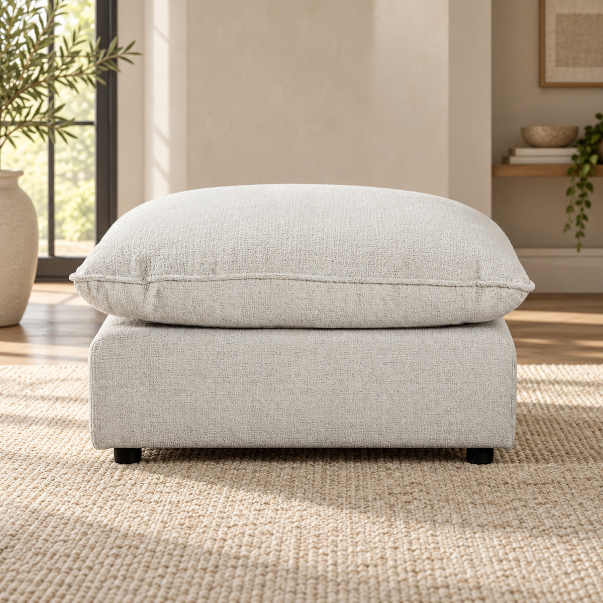 Bradman Snow duck feather ottoman with plush square cushion and textured Shay fabric upholstery, front view