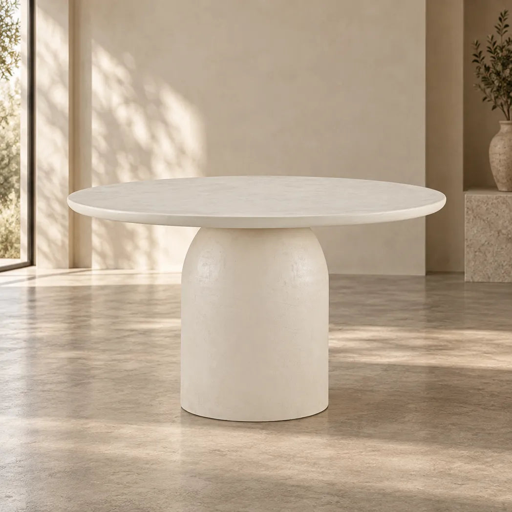 Calisto 1.2m Pebble round dining table with matte micro-cement finish and cylindrical pedestal base, front view
