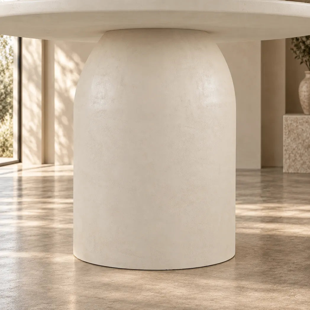 Calisto 1.2m Pebble round dining table with matte micro-cement finish and cylindrical pedestal base, leg view