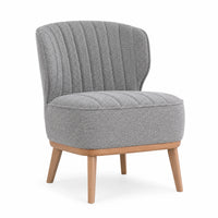 A modern accent chair with a textured gray bouclé fabric, featuring a vertically channel-tufted backrest and a rounded seat cushion, supported by light natural wood legs on a white background.