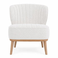 A modern accent chair upholstered in a textured cream bouclé fabric with vertical channel tufting on the backrest and seat, supported by light natural wood legs, shown against a plain white background.