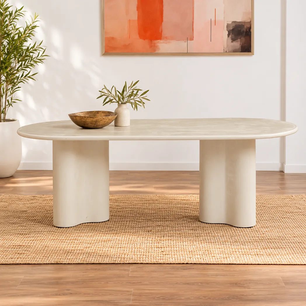 Coastal 2.2m Pebble dining table with matte micro-cement finish, softly rounded tabletop and sculptural curved pedestal bases