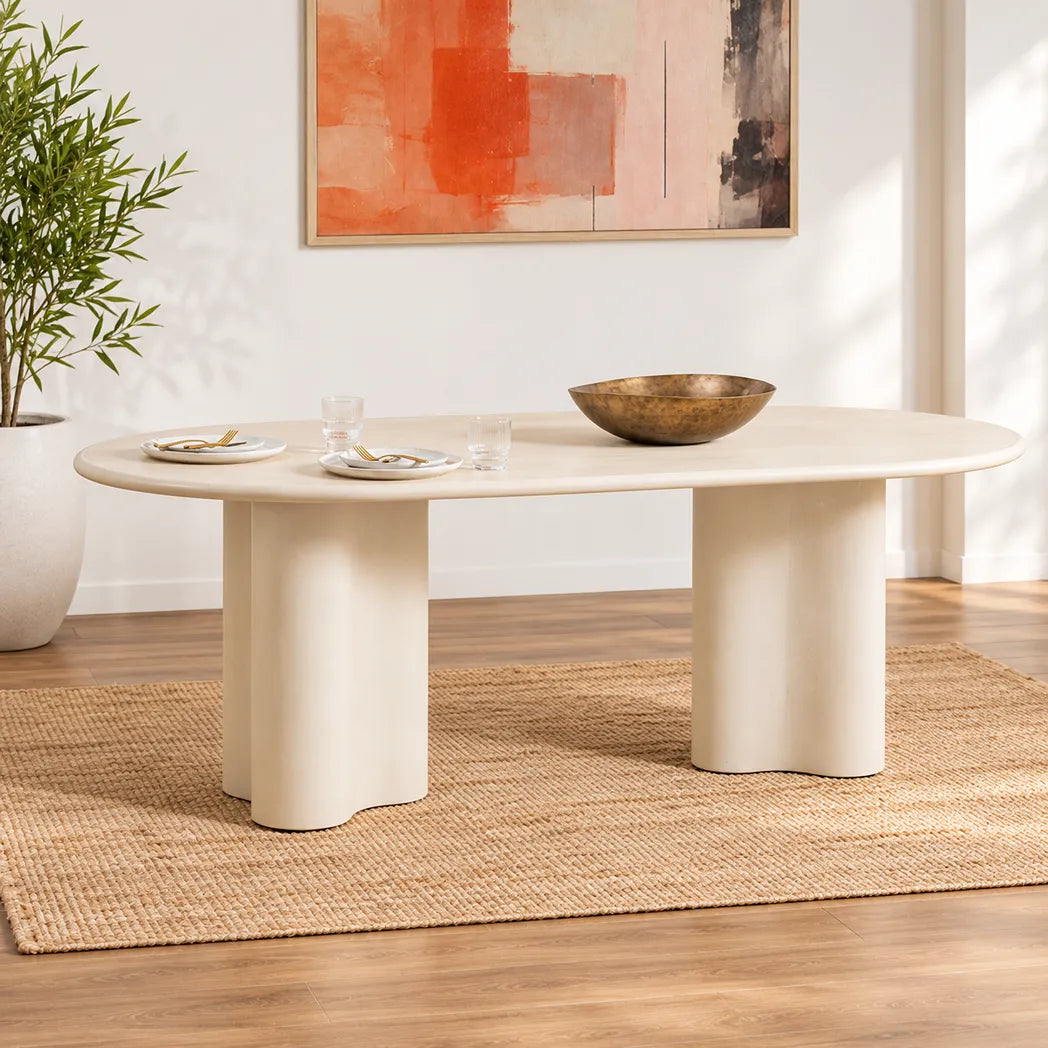 Coastal 2.2m Pebble dining table with matte micro-cement finish, softly rounded tabletop and sculptural curved pedestal bases