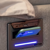 Phone holder with screen on a gray bed