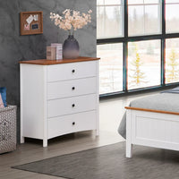 White dresser with wooden top in a bedroom setting with large windows.