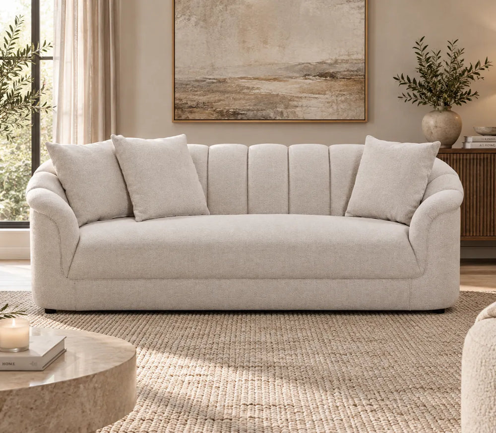 Eastwood beige 3 seater sofa with curved arms, vertical channelled backrest and three scatter cushions, front view