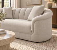 Eastwood beige 3 seater sofa with curved arms, vertical channelled backrest and three scatter cushions, arm rest view