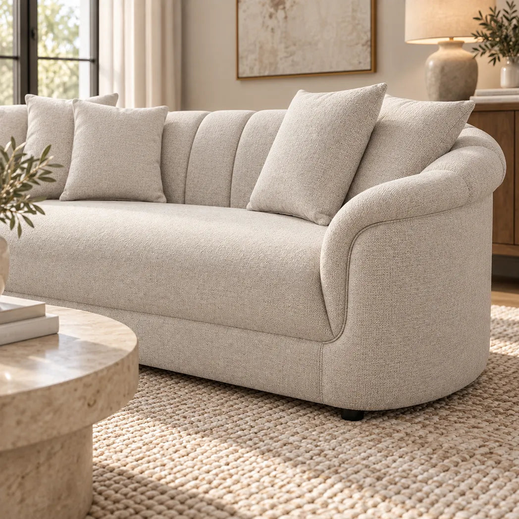 Eastwood beige 4 seater sofa with curved arms, vertical channelled backrest and four scatter cushions, side view