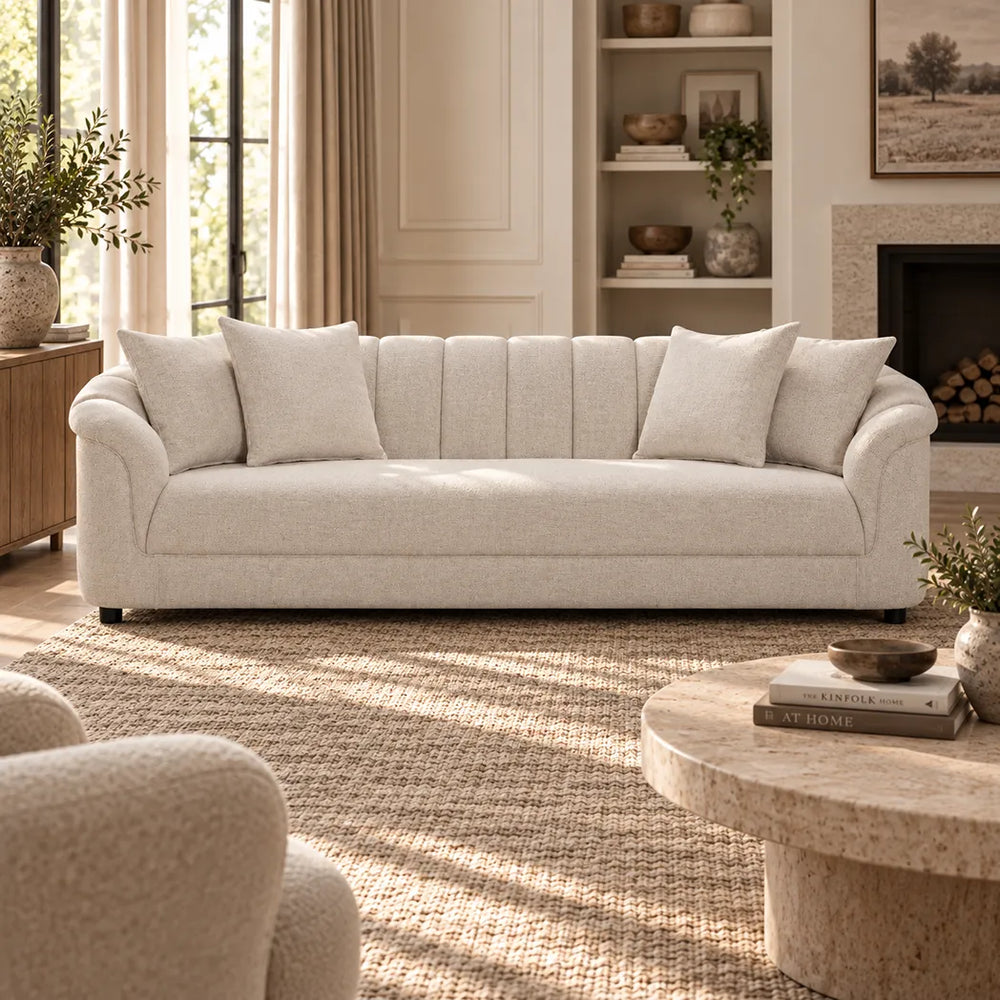 Eastwood beige 4 seater sofa with curved arms, vertical channelled backrest and four scatter cushions, front view