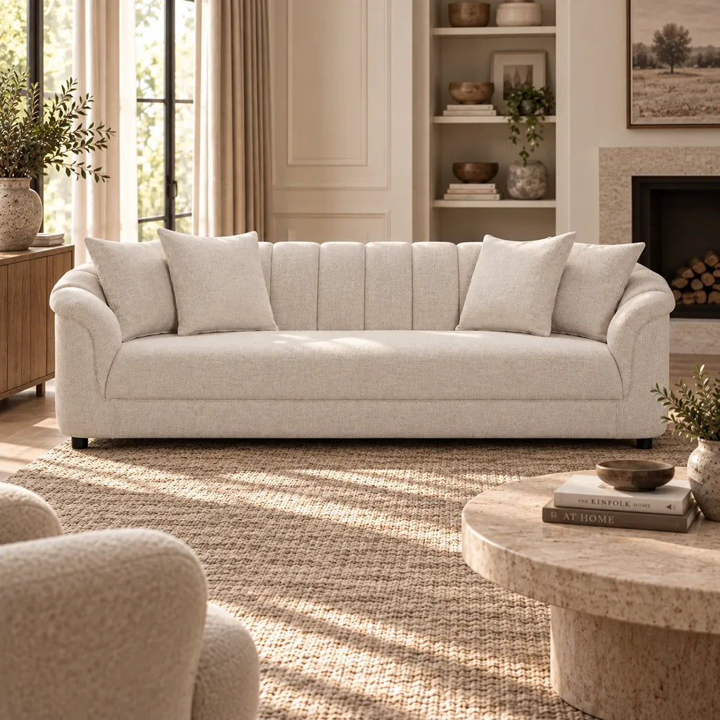 Eastwood beige 4 seater sofa with curved arms, vertical channelled backrest and four scatter cushions, front view