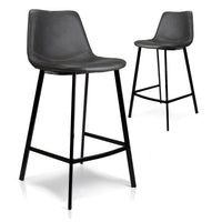 Two modern bar stools with black faux-leather seats and slim black metal legs, shown on a clean white background.