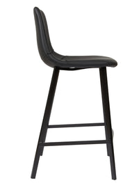 A modern black bar stool with a padded seat and backrest, supported by four tapered legs and a front support bar, shown against a plain white background.