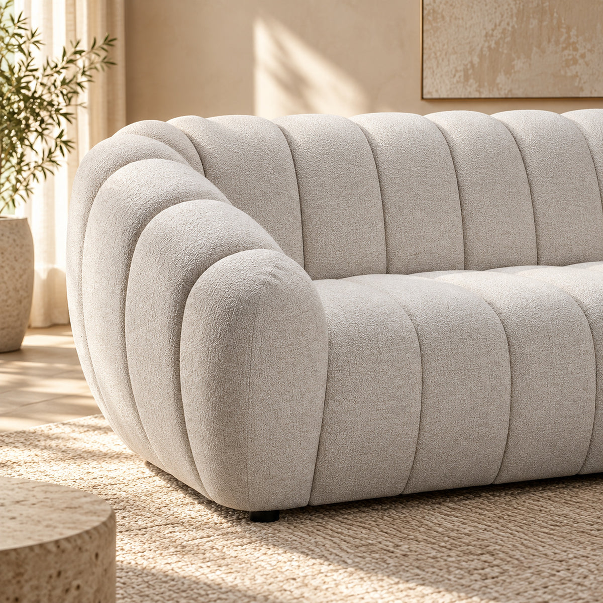 Kenya Beige 3 seater sofa with curved low-profile design, slanted arms and vertical panel detailing, close up view