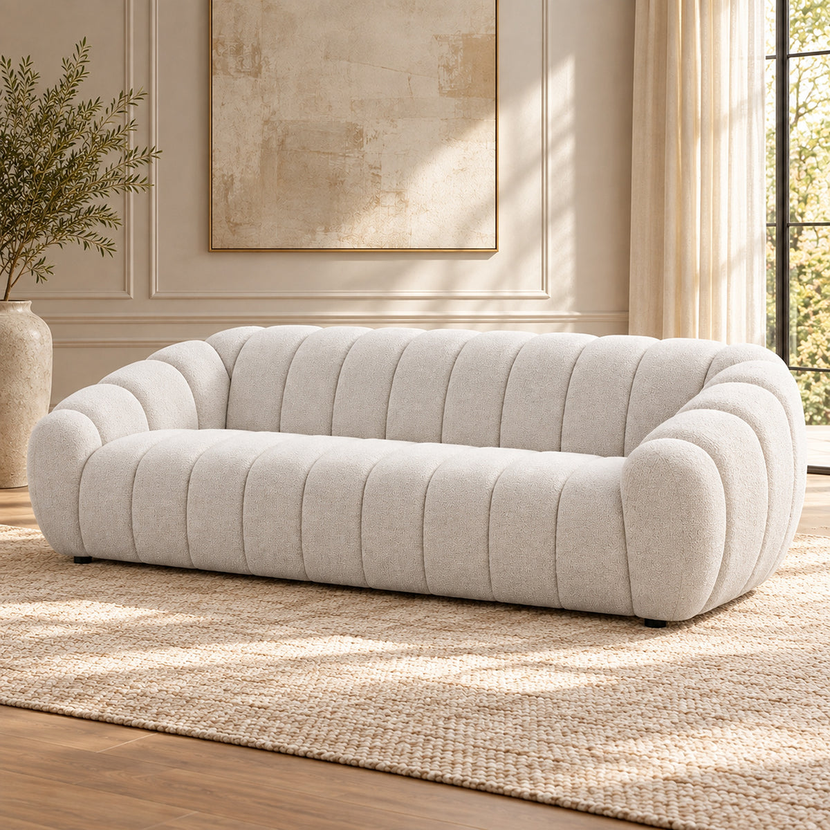 Kenya Beige 4 seater sofa with curved low-profile design, slanted arms and vertical panel detailing, angled view