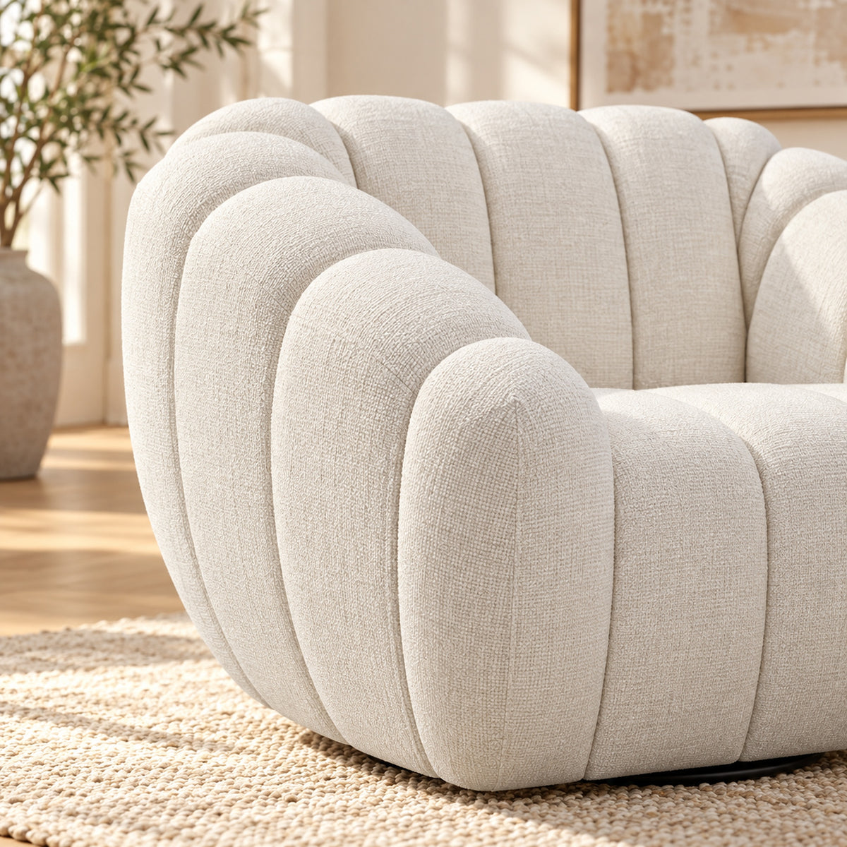 Kenya Beige swivel armchair with curved low-profile design, slanted arms and vertical panel detailing, close up view