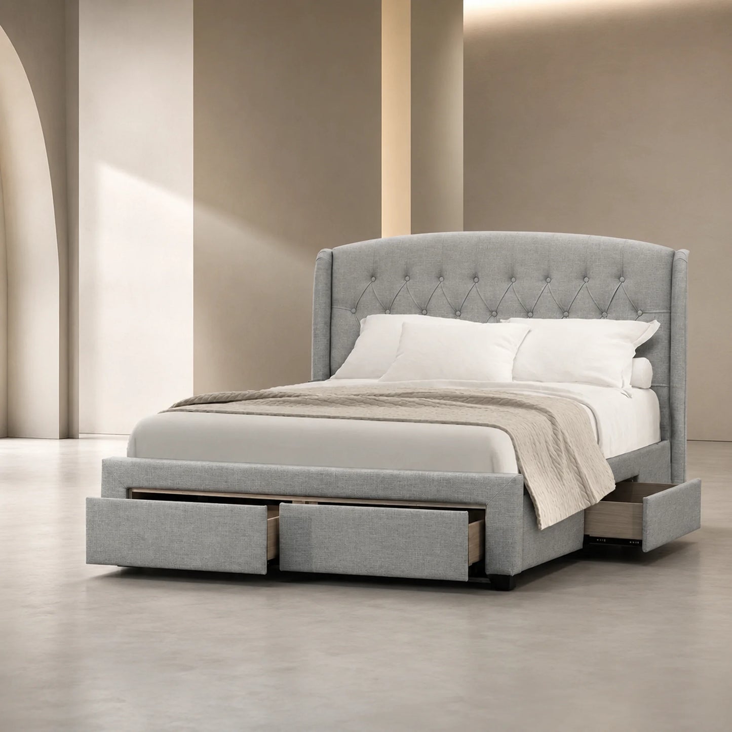 A modern platform bed with a tall tufted headboard and built-in storage drawers at the base, upholstered in light gray fabric and shown with white bedding in a minimalist beige-toned room.