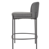 A modern bar stool with a gray upholstered seat and curved backrest, supported by a slim black metal frame with a footrest.