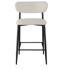 A modern bar stool with a textured cream boucle upholstered seat and curved backrest, supported by a slim black metal frame with tapered legs and a footrest.