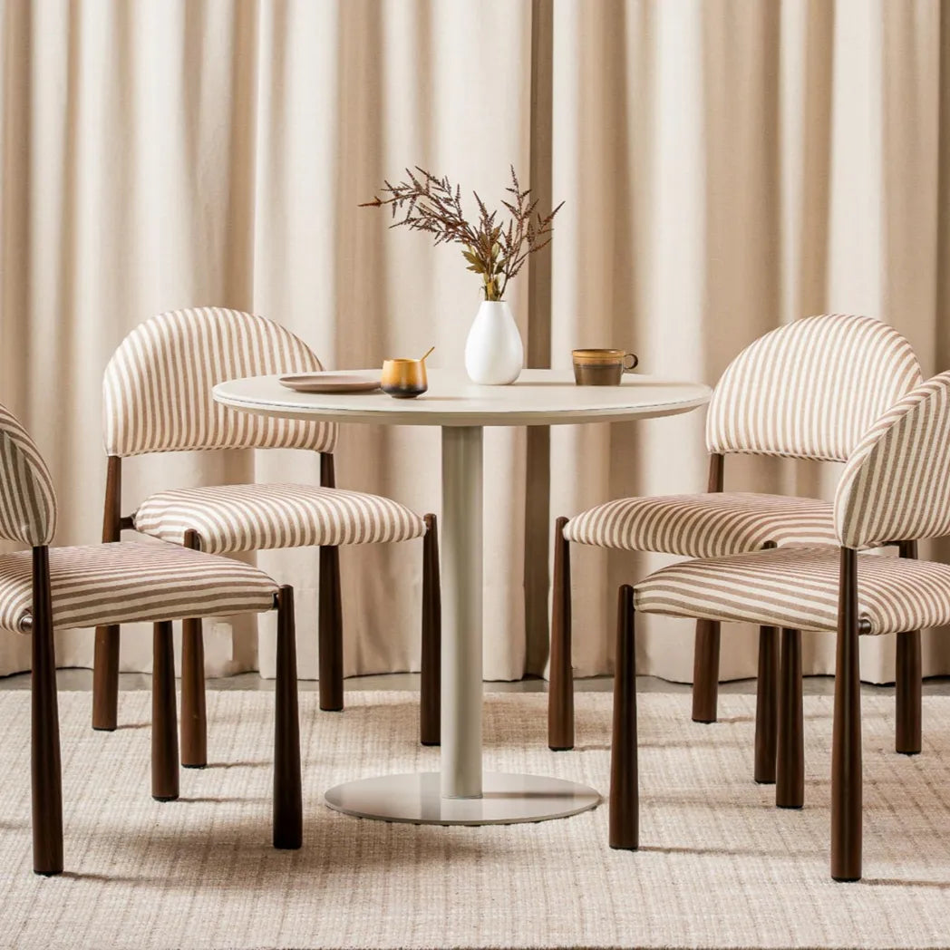 Positano 90cm Matte Tofu round dining table with matte tempered glass top and powder-coated metal pedestal base, front view