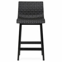 A modern black bar stool with a woven textured seat and backrest, supported by a slim black metal frame with a footrest.