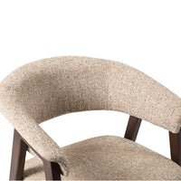 Close-up of Rovano modern upholstered dining chair with a curved backrest and seat, featuring a textured beige and brown woven fabric and dark wood legs.