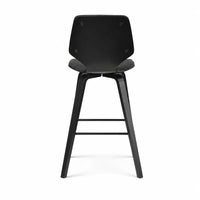 A modern black bar stool with a molded seat and backrest, supported by four tapered legs with a central footrest, shown from the front on a white background.