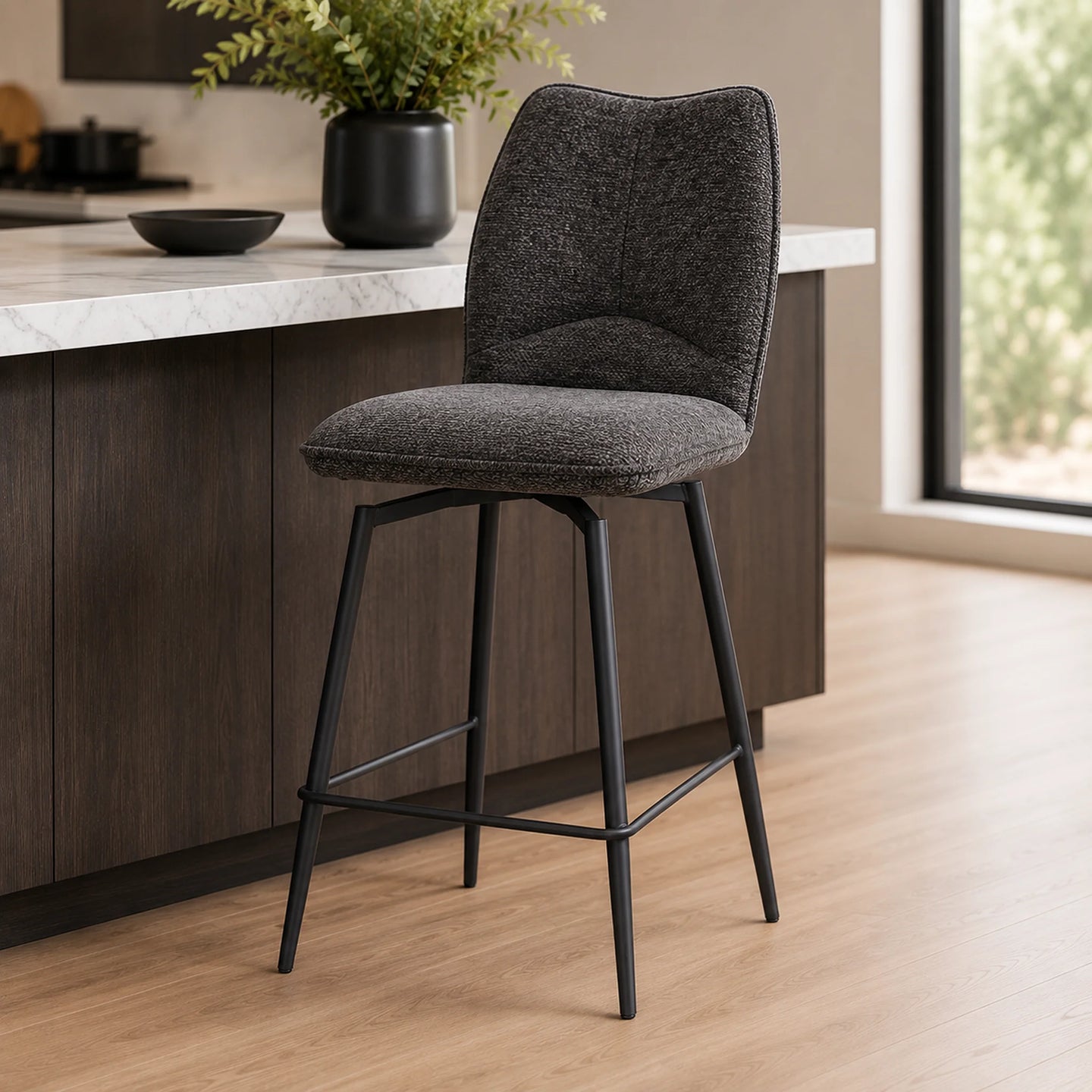 A modern bar stool with a textured dark gray upholstered seat and curved backrest, supported by a slim black metal frame
