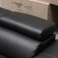Close-up of a black leather sofa armrest with a padded top cushion