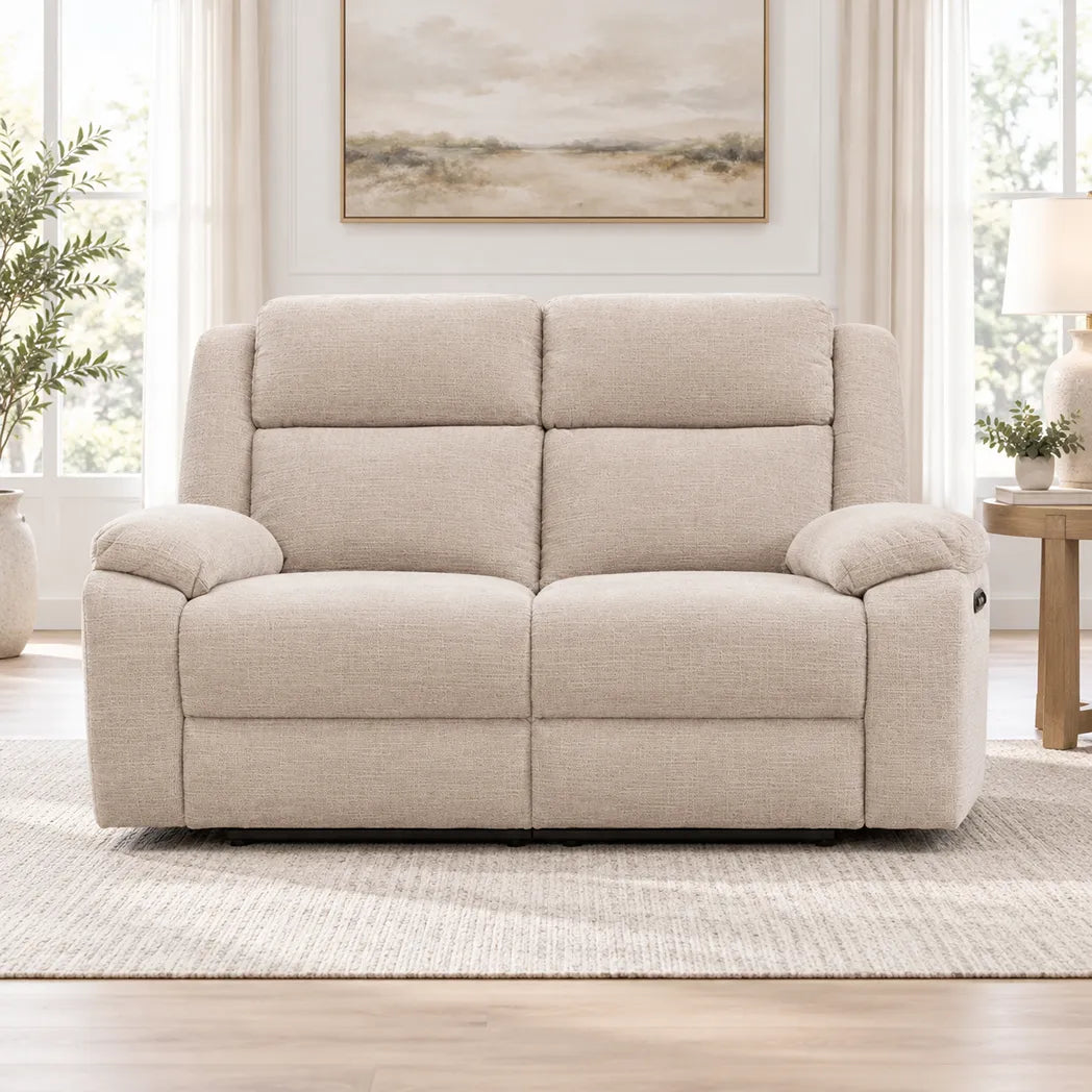 Stella beige 2 seater electric recliner lounge with padded armrests and high backrests, three-quarter view
