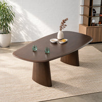 Tierra 2.2m Walnut dining table with sculptural asymmetrical ash veneer tabletop, softly rounded edges and curved pedestal legs, angled view