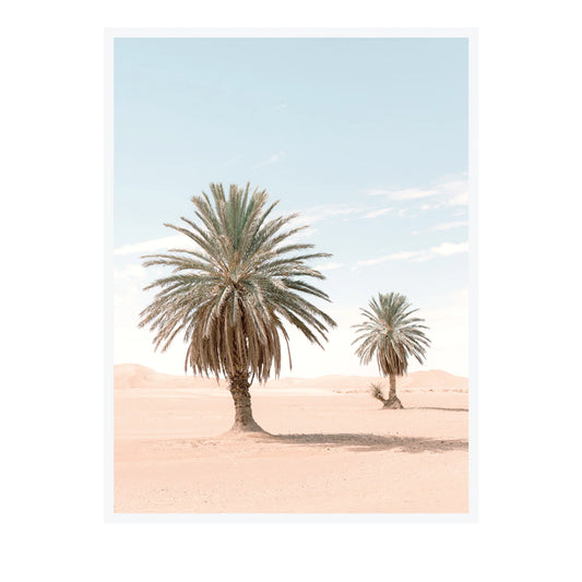 A minimalist art print depicting two palm trees in a desert landscape under a pale blue sky, presented with a clean white border.