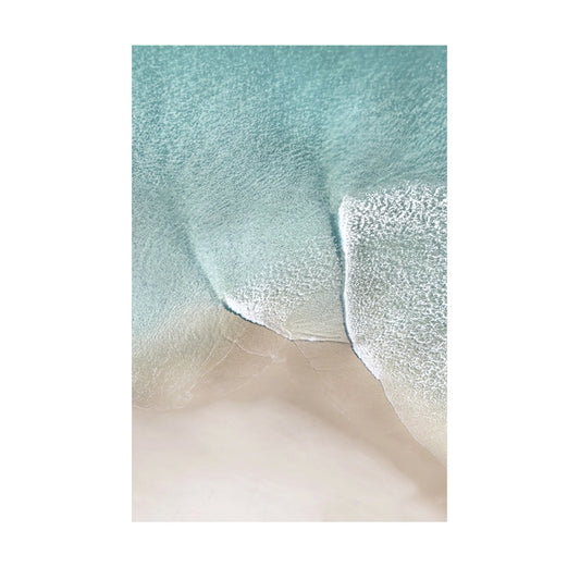 A close-up of a textured fabric or material sample with a soft aqua-blue upper area and a pale warm beige lower area, shown against a white surround.