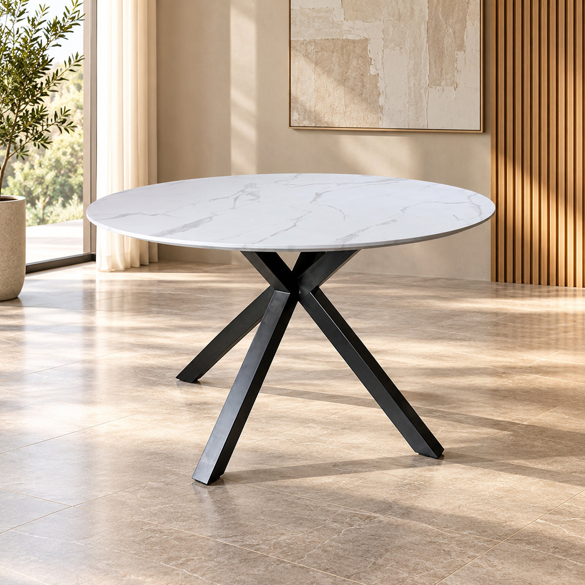 Zorian 1.2m White round dining table with marble-look top and sculptural black powder-coated metal legs, front view
