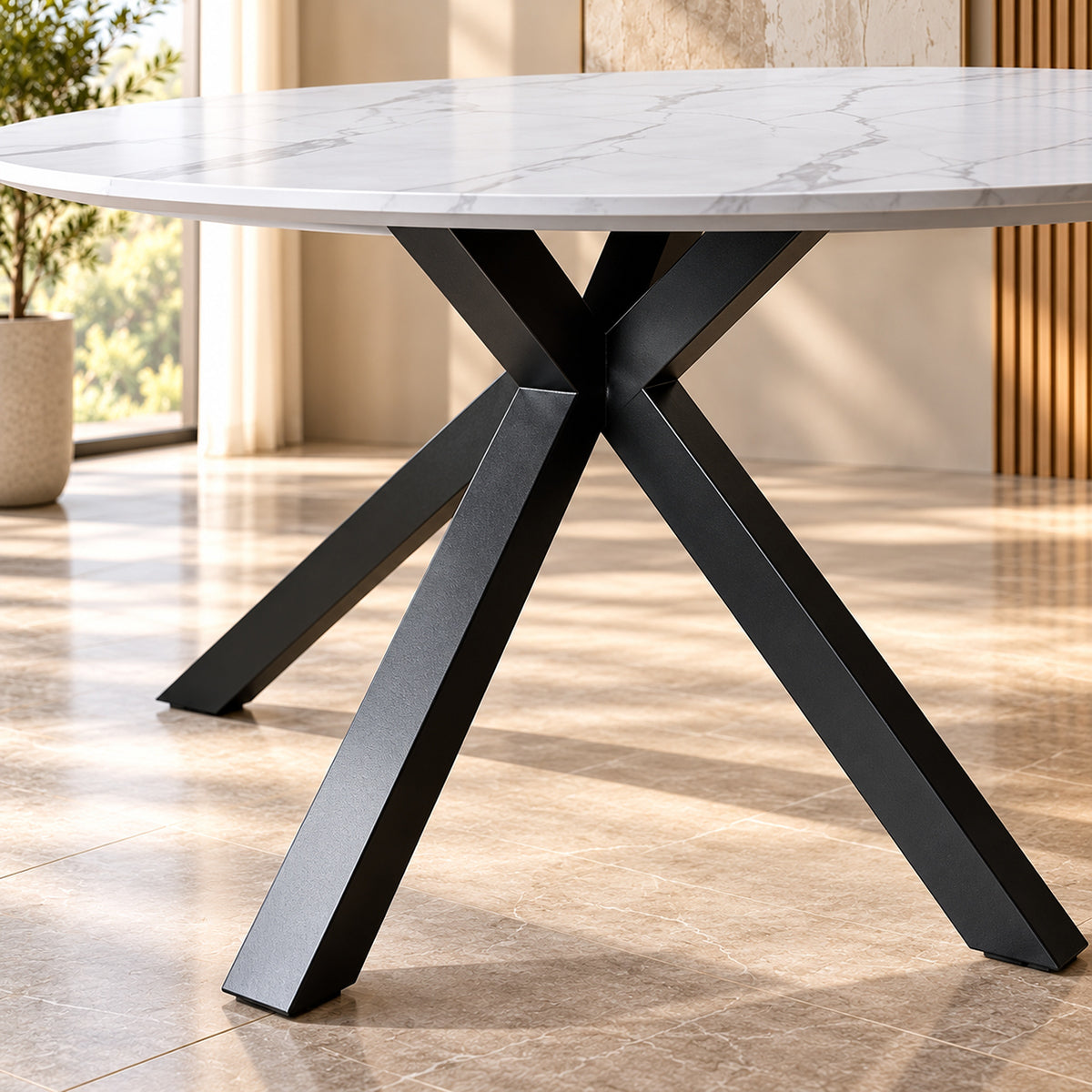 Zorian 1.2m White round dining table with marble-look top and sculptural black powder-coated metal legs, leg view